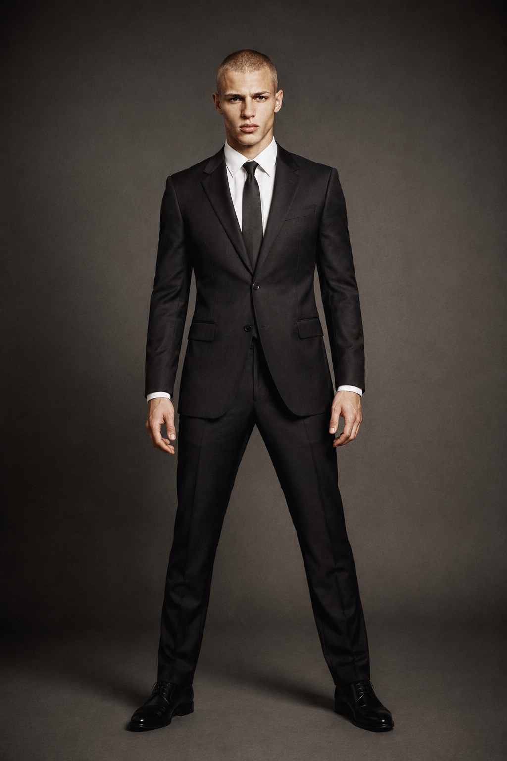 Damien, male AI fashion model wearing a black suit, white shirt and tie, full-body menswear editorial by VIDA AI